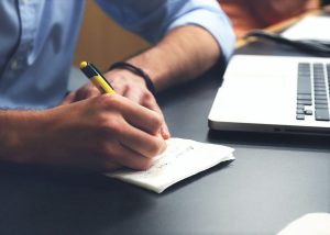 Ręce człowieka wypełniającego ankietę przy komputerze